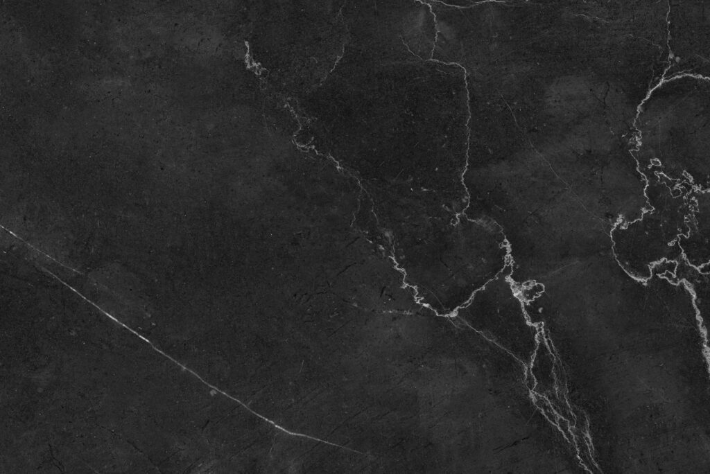 High-resolution black marble texture with striking white veins, ideal for design backgrounds.